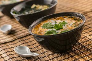 Traditional thai soup Tom Yum with shrimp and coconut milk photo