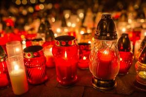 Many burning candles in the cemetery at night on the occasion souls of the deceased photo