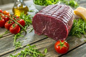 Italian bresaola with arugula tomatoes and olive oil photo