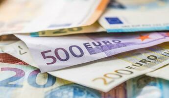 Euro banknotes in detail on the pile of other nominal banknotes photo