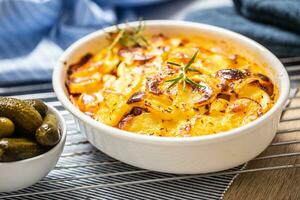 Roasted potatoes in baking dish traditional easten european food titled as france potato photo