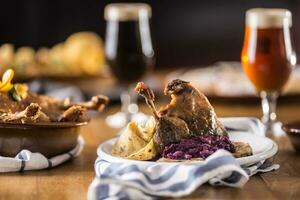 Roasted christmas duck leg red cabbage dumplings liver draft beer and baked buns photo