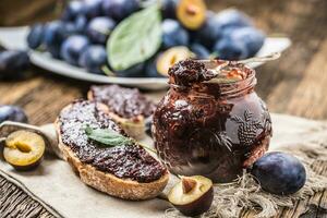 Breakfast from homemade plum jam bread and ripe plums. photo