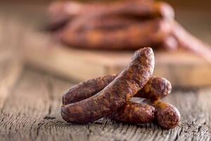 Sausages. Smoked Sausages. Chorizo sausages with vegetable rosemary spices and kitchen utensil. photo