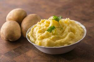 Mashed potatoes in bowl decorated with parsley herbs photo