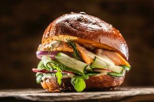 Salmon burger stuffed with vegetable salad avocado and dill photo