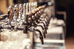 Broad variety of draft beer pipes in a pub ready for serving beer photo