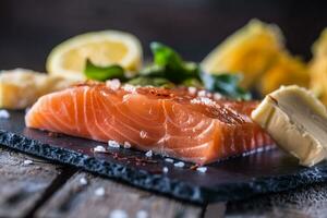 Raw salmon fillets with  lime lemon salt and dried saffron photo