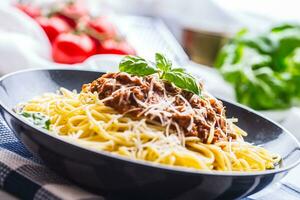 Spaghetti Bolognese. Pasta spaghetti Bolognese with basil and decoration in restaurant or home photo