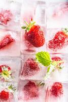 Three rows of ice cubes with strawberries - Top of view photo