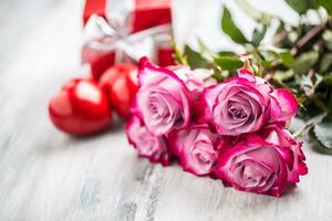 Roses. Pink roses with two hearts and red gift. photo