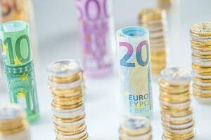 Rolled euro banknotes and coins towers stacked in other positions photo