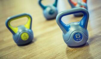 Kettlebell in gym on wooden floor. photo