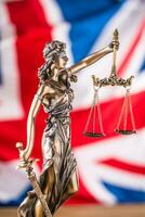 Lady Justice and United Kingdom flag. Symbol of law and justice with UK Flag photo