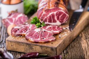 Pork meat.Pork chop smoked. Traditional smoked meat on oak wooden table in other positions photo