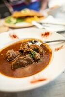 Beef or veal goulash served in a plate with juice stew, served in a plate photo