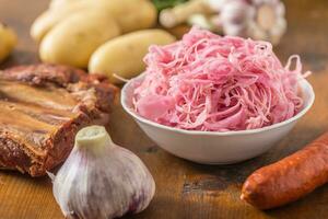 Sour cabbage with smoked ribs sausages potatoes and garlic photo