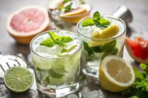 Three colorful gin tonic cocktails in whiskey glasses on bar counter in pup or restaurant photo