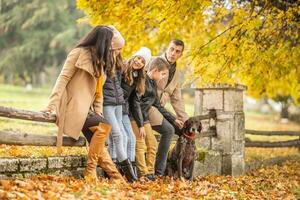 A family talks and enjoys moments outdoors during a colorful fall day photo