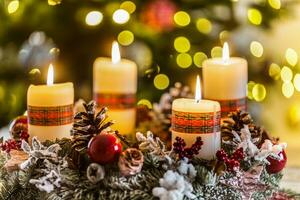 Advent wreath with four white burning candles christmas ball and decorations on a wooden background with festive atmosphere photo