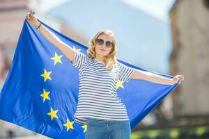 Attractive happy young girl with the flag of the European Union photo