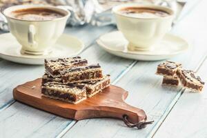 A waffle cake with caramel chocolate and walnuts.Traditional slovak and czech cake grilaz with coffee photo