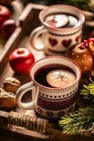 Two cups with Christmas hot punch cooked from red wine, rum and fresh fruit, flavored with cloves and cinnamon photo