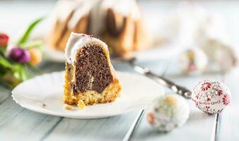 A cut piece of Easter marble cake on a white plate photo