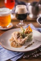 Rabbit leg with mashes potatoes and decoration on plate in restaurant photo