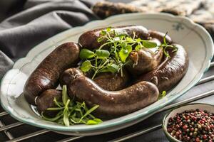 Roasted sausages in pan with rosemary. Traditional european food bratwurst jaternice or jitrnice photo