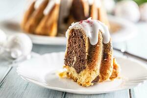 A cut piece of Easter marble cake on a white plate photo