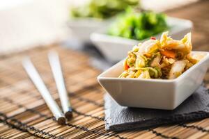 Mixed salad with chinese cabbageon slate board photo