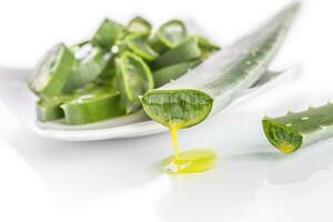 Slices of aloe vera with gel on white background photo