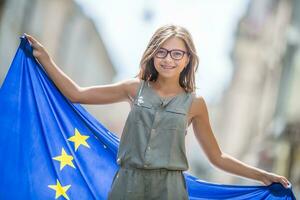 Cute happy young girl with the flag of the European Union photo