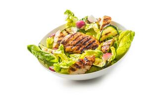 Chicken breast. Grill chicken breast with lettuce salad zucchini and radish isolated on white photo