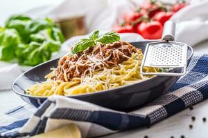 Spaghetti Bolognese. Pasta spaghetti Bolognese with basil and decoration in restaurant or home photo