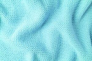 Pastel turquoise knitwear wool fabric texture background. Abstract textile backdrop photo