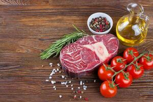 Cooking ingredients. Fresh raw meat beef steak with bone. photo