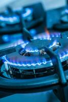 Close-up kitchen stove cook with blue flames burning photo