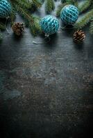 Top of view christmas balls fir tree pine cones on free concrete background photo