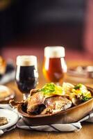 Roasted christmas duck leg red cabbage dumplings liver draft beer and baked buns photo