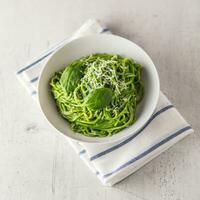 Spaghetti. Green spaghetti with spinach and parmesan. Italian and mediterranean cuisine photo