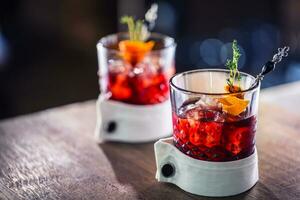 Fresh cocktail drink with ice fruit and herb decoration. Alcoholic, non-alcoholic drink-beverage at the bar counter in the pub restaurant  or night club photo