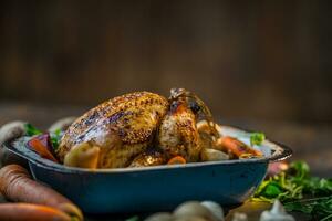 Roast whole turkey or  chicken in old pan with vegetables photo