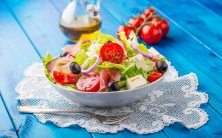 Salad. Fresh summer lettuce salad.Healthy mediterranean salad olives tomatoes parmesan cheese and prosciutto photo