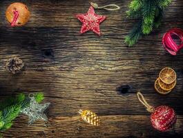 Christmas. Christmas composition fir branches pine cones jingle bells stars and ribbon on rustic wooden table photo