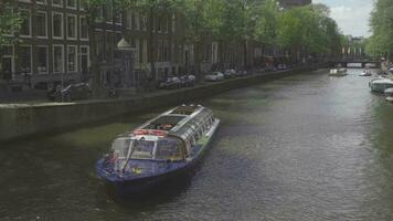 AMSTERDAM, THE NETHERLANDS JULY 28, 2017 - The excursion cruise ship on the canal in Amsterdam video