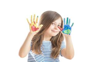 Little schoolgirl shows hands painted with watercolors - isolated on white photo