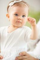 Small toddler girl playing held by an adult at home photo