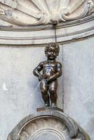 Manneken Pis Little man Pee or le Petit Julien, a very famous bronze sculpture landmark in Brussels photo